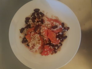 Tomatoes, red beans, integral rice, petit chef species with oregano, basil, romarin. Lunch for teleworking hard during COVID-19 