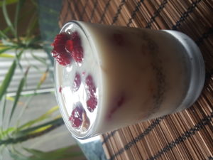 Desert with raspberries, strawberry marmalade, chia, muesli and creamy caramelized toasted almond milk 