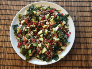 Superfood lunch for gaining strength and less pain during menstruating : kale, chia tricolore, avocado, salmon, pomegranate 