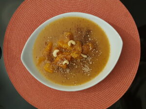 Pumpkin soup : pumpkin, potatoes, onion, cashew, flax and goji seeds, four peppers