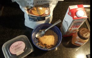 Prunes, apple, cinnamon, oatmeal, almond milk, maca powder, drops of dark chocolate to melt