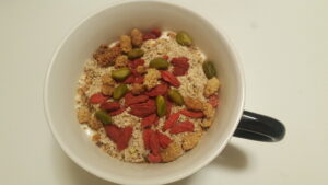 Morning healthy and full of strength breakfast. Soy iogurt, mango and baobad, ground almonds, chia and oats, whiteberries, goji berries, and pistachios