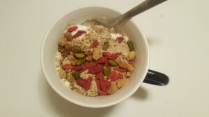 Morning healthy and full of strength breakfast. Soy iogurt, mango and baobad, ground almonds, chia and oats, whiteberries, goji berries, and pistachios